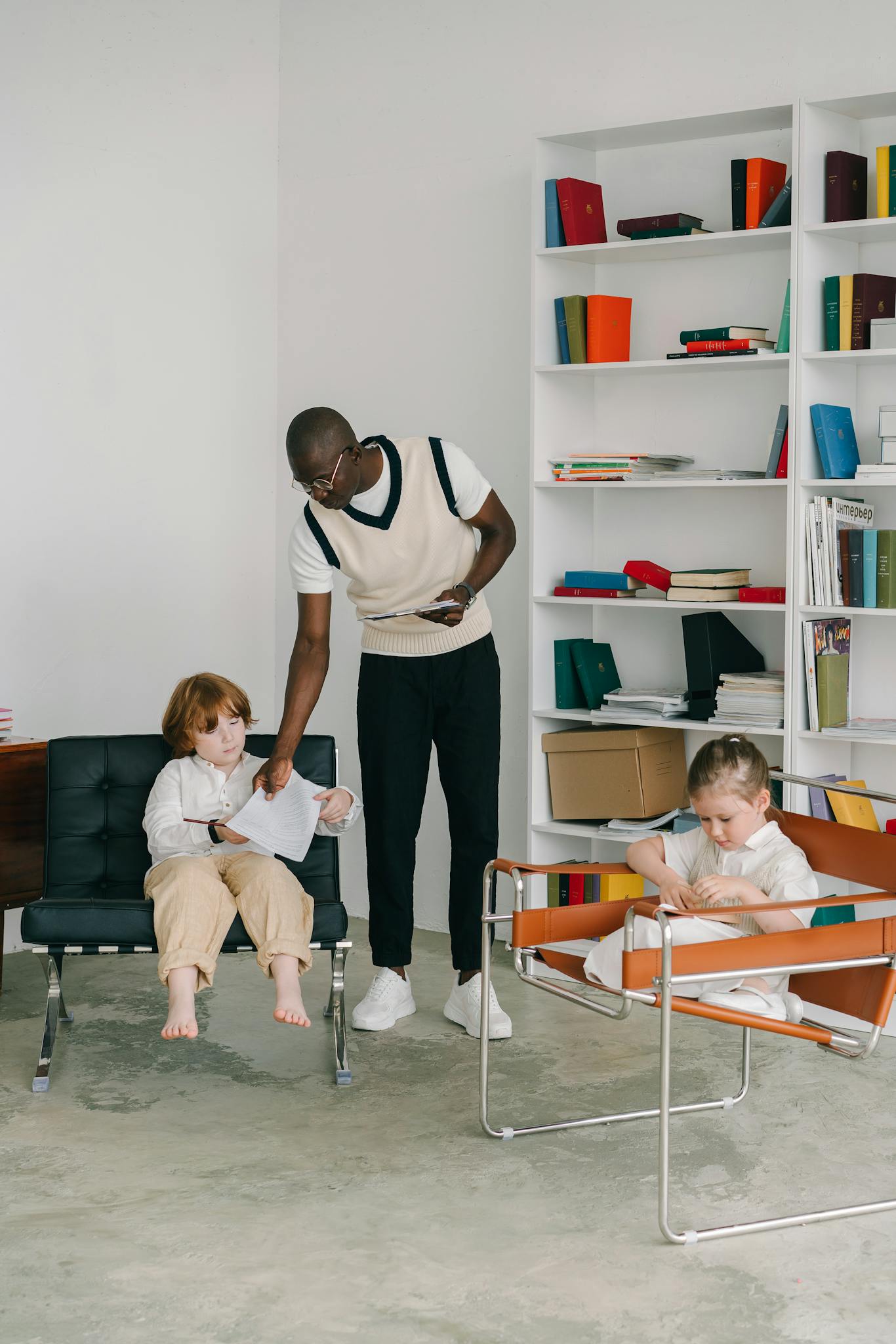 Therapist interacting with children during a therapy session in an office environment.